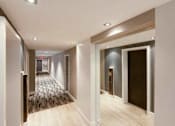 Thumbnail 10 of 17 - a hallway with white walls and a wooden floor at 1841 Columbia Road Apartments, Washington DC