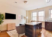 Thumbnail 2 of 17 - a kitchen and living room with two windows and a tv on the wall at 1841 Columbia Road Apartments, Washington DC