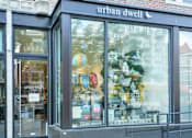 Thumbnail 15 of 17 - a store front with a bunch of items in the window at 1841 Columbia Road Apartments, Washington, 20009