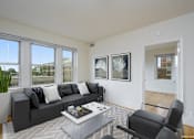 Thumbnail 4 of 17 - a living room with a black couch and a white coffee table at 1841 Columbia Road Apartments, Washington, DC, 20009