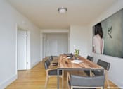 Thumbnail 3 of 17 - a room with a wooden table and chairs and a large painting on the wall at 1841 Columbia Road Apartments, Washington DC, 20009