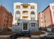 Thumbnail 5 of 13 - a blue and white building with a car parked in front of it