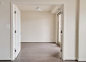 Thumbnail 8 of 13 - an empty room with a door open and a ceiling fan
