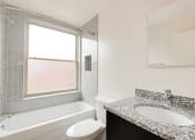 Thumbnail 10 of 13 - a bathroom with a sink toilet and bathtub