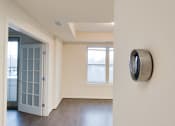 Thumbnail 11 of 13 - an empty room with a door open and a clock on the wall