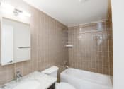 Thumbnail 9 of 25 - a bathroom with a sink toilet and bathtub