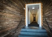 Thumbnail 10 of 25 - a hallway with wood paneling and a staircase