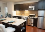 Thumbnail 12 of 25 - a kitchen with a stove a refrigerator and a sink