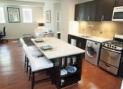 Thumbnail 13 of 25 - a kitchen with a counter top and a stove top oven