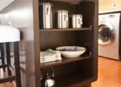 Thumbnail 14 of 25 - a small kitchenette with a counter and a washing machine