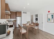 Thumbnail 19 of 66 - A modern kitchen with a dining table set for two.