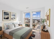 Thumbnail 2 of 66 - A bedroom with a large bed and a view of the city.