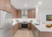 Thumbnail 24 of 66 - A modern kitchen with wooden cabinets and stainless steel appliances.