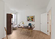 Thumbnail 27 of 66 - A room with a wooden floor and a painting on the wall.