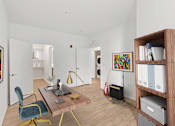 Thumbnail 34 of 66 - A room with a desk, chair, and bookshelf.