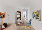 Thumbnail 39 of 66 - A room with a red guitar, a microphone, a bookshelf, a chair, and two paintings on the wall.