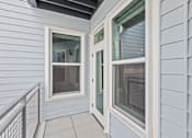 Thumbnail 42 of 66 - A white door with a window on the side is open.