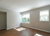 Thumbnail 5 of 27 - a bedroom with two windows and hardwood floors