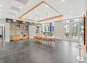 Thumbnail 65 of 66 - A modern open space with a kitchen, dining area, and a bar.