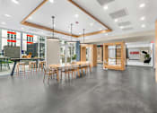 Thumbnail 63 of 66 - A modern dining area with a long table and chairs.