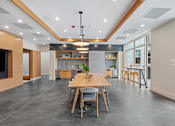 Thumbnail 66 of 66 - A modern kitchen with a dining table and chairs.