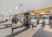 Thumbnail 49 of 66 - A well-lit gym with various exercise equipment.