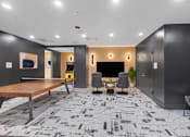 Thumbnail 60 of 66 - A modern office space with a patterned carpet and a wooden table.