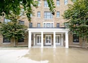 Thumbnail 15 of 22 - a large brick building with white pillars in front of it