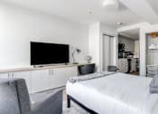 Thumbnail 10 of 17 - a bedroom with a large bed and a flat screen tv