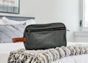 Thumbnail 8 of 17 - a bag sitting on top of a bed