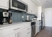 Thumbnail 7 of 17 - a kitchen with a stove top oven next to a refrigerator