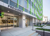 Thumbnail 5 of 17 - a large green and white building with a staircase in front of it