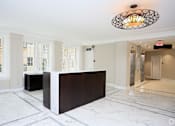Thumbnail 10 of 22 - a large lobby with a reception desk and a large chandelier