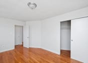 Thumbnail 9 of 16 - the living room with wood floors and white walls and sliding closet doors