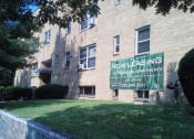 Thumbnail 15 of 16 - an apartment building with a sign for new leasing