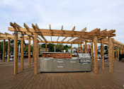 Thumbnail 12 of 22 - an outdoor kitchen with a wooden pergola
