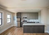 Thumbnail 1 of 19 - a kitchen with a stove a refrigerator and a microwave