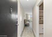 Thumbnail 2 of 14 - a hallway with a black door and a rug on the floor