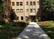 Thumbnail 16 of 19 - a large brick building with a sidewalk in front of it