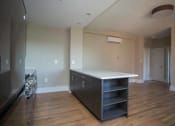 Thumbnail 4 of 19 - a kitchen with a counter top and a stove