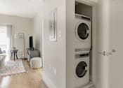 Thumbnail 6 of 22 - a washer and dryer in a room with a couch and a tv