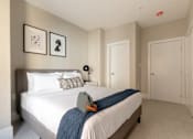 Thumbnail 7 of 22 - a bedroom with a bed and two doors