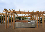 Thumbnail 19 of 22 - an outdoor kitchen with a pergola on top of it