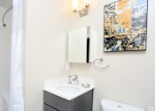 Thumbnail 8 of 22 - a bathroom with a white sink and toilet and a white shower curtain