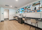 Thumbnail 9 of 47 - Coffee bar with counter seating and open shelving at The Yancey Apartments, Charlotte, NC 28217