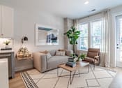 Thumbnail 6 of 47 - Living room with modern furniture and area rug at The Yancey Apartments, North Carolina, 28217