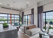 Thumbnail 44 of 47 - Open concept living area with floor to ceiling windows at The Yancey Apartments, North Carolina, 28217