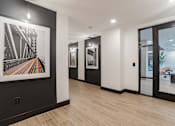Thumbnail 47 of 47 - Contemporary hallway with framed bridge artwork and pendant lighting at The Yancey Apartments, Charlotte, 28217