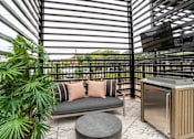Thumbnail 35 of 47 - Covered patio with outdoor kitchen and lounge seating at The Yancey Apartments, Charlotte, North Carolina