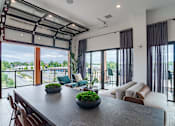 Thumbnail 39 of 47 - Open concept living area with garage style glass door at The Yancey Apartments, Charlotte, North Carolina